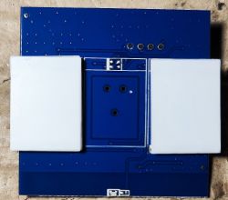 Blue PCB with white components and visible soldering points.