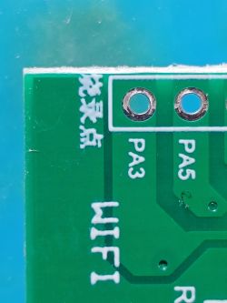 A section of a green PCB showing the labels “WIFI”, “PA3”, “PA5”, Chinese characters, and two mounting holes.