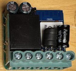 CB3S Electronic Module with Capacitors Electronic module labeled CB3S, capacitors, and screw terminals on a wooden surface.