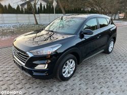 Black Hyundai SUV parked on paving stones, front-left three-quarter view.