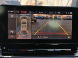Car infotainment screen showing reverse camera view and parking sensor visualization