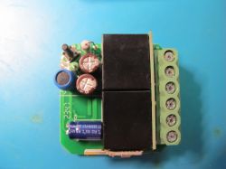 Electronic module with soldered components and screw terminals.