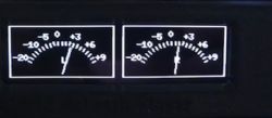 Two analog-style VU meters with white needles on black background