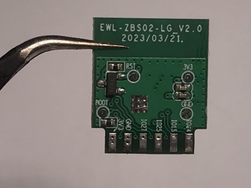 Small green circuit board with labels and electronic components.