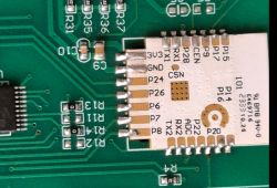 Close-up of a PCB with an ESP8685-WROOM-06-H4 module and zero-ohm resistors R13 and R14.