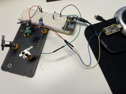 Electronic kit with breadboard, microcontroller, and wires.