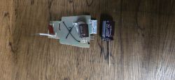LED driver board on a wooden surface with a larger 22 µF 400 V capacitor placed beside it