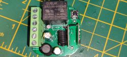 Circuit Board with Relay and Antenna Top view of a circuit board with a relay, capacitors, and an antenna.