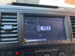 Car radio screen model X-230 displaying a reversing image with a vehicle visualization.
