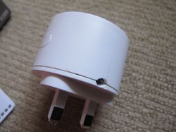 Drilled Hole in Sonoff S60TPG iPlug UK Plug Case Close-up of a UK smart plug with a drilled hole at the seam and visible crack along the plastic enclosure.