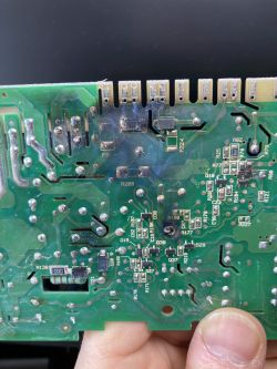 Close-up of a damaged dishwasher control board.