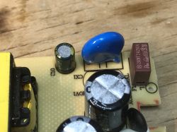 Power Supply Interior with Visible Electronic Components Close-up of a power supply interior showing electronic components on a PCB.