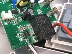 Close-up of a PCB from an ATLO-S1IP5-TUYA outdoor socket, showing the ESP8285 chip and XHONG relay.