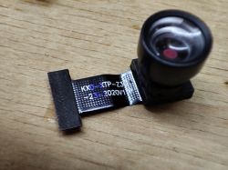 Camera module labeled KXD-XTP-Z30-23-2020V1.0 on a wooden surface