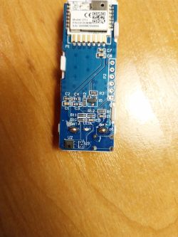 Close-up of a blue circuit board with electronic components.