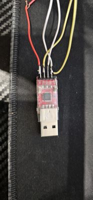 Close-up of a USB module with attached wires in various colors.