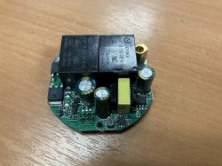 Circuit board with electronic components on a wooden surface.