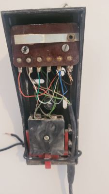 Old intercom with visible colored wires connected.