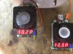 Test Loads for Measuring Current Performance Two test loads with fans and digital displays on a table.