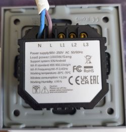 Back side of a smart wall switch showing technical specifications and wiring.