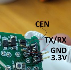 Close-up of a circuit board with labeled elements CEN, TX/RX, GND, and 3.3V.