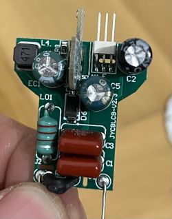 Close-up of an LED bulb PCB with various electronic components.