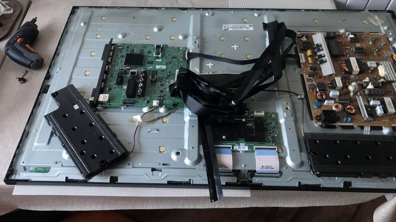 LED Backlight Repair in Television Interior of a disassembled TV with visible circuit boards and wires.