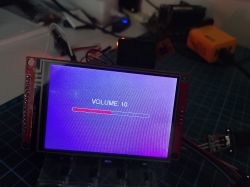 TFT screen on a circuit board shows “VOLUME: 10” with a volume bar on a purple background.