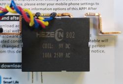 HEZ 802 relay with 9V DC coil and marking 100A 250V AC against a manual.