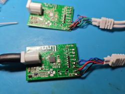 Two PCB boards with Wi-Fi modules and wires soldered to labeled pins
