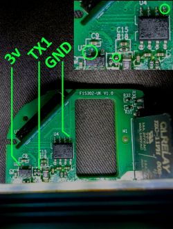 Close-up of a circuit board with marked soldering points: 3V, TX1, and GND.