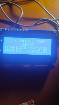 Ekran LCD z datą 1 stycznia 2000 i czasem lokalnym 01:52:51 oraz UTC 00:52:50