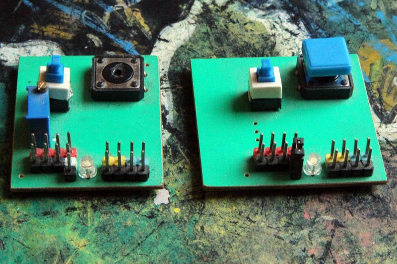 Two green electronic modules with buttons, pin headers and LEDs