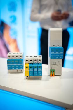 Modular electrical devices on a counter, with a blurred person in the background.