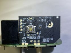 Close-up of a black PCB with a RESET button and markings “HSF-94V-0” and “S30WIFI_V1B”