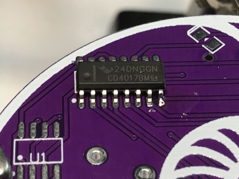 CD4017BM Integrated Circuit on PCB Close-up of a CD4017BM integrated circuit mounted on a purple PCB.