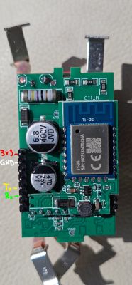 Electronic module with ESP8266 chip and labeled pins Tx, Rx, GND, 3V3.