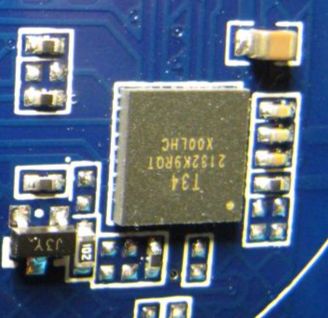 Close-up of an integrated circuit on a blue PCB with SMD components