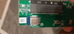 Close-up of a pressure monitor circuit board with a BLE module and LED displays.