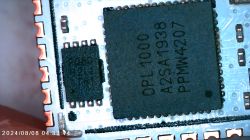 Close-up of a circuit board with two black integrated circuits.
