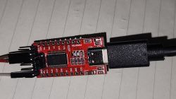 FTDI USB to UART adapter on white paper.