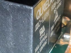 Close-up of QLRELAY Relay Close-up of a QLRELAY relay on a circuit board with visible technical parameters.