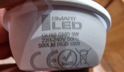 Close-up of a Smart LED 5W GU10 bulb with technical markings.