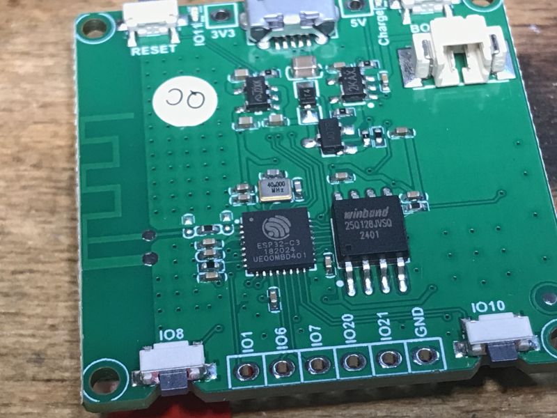 Circuit Board with ESP32-C3 Microcontroller Close-up of a circuit board with an ESP32-C3 microcontroller and Winbond chip.