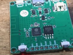 Close-up of a circuit board with an ESP32-C3 microcontroller and Winbond chip.