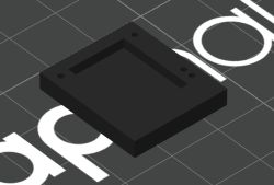 Black rectangular enclosure with four holes and a central recess