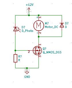 Schemat elektryczny z silnikiem DC, fotodiodą, rezystorem i tranzystorem NMOS podłączonymi do źródła 12V.