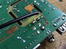 Soldered Connections on PCB with Wires Close-up of a green PCB with soldered wires and electronic components.