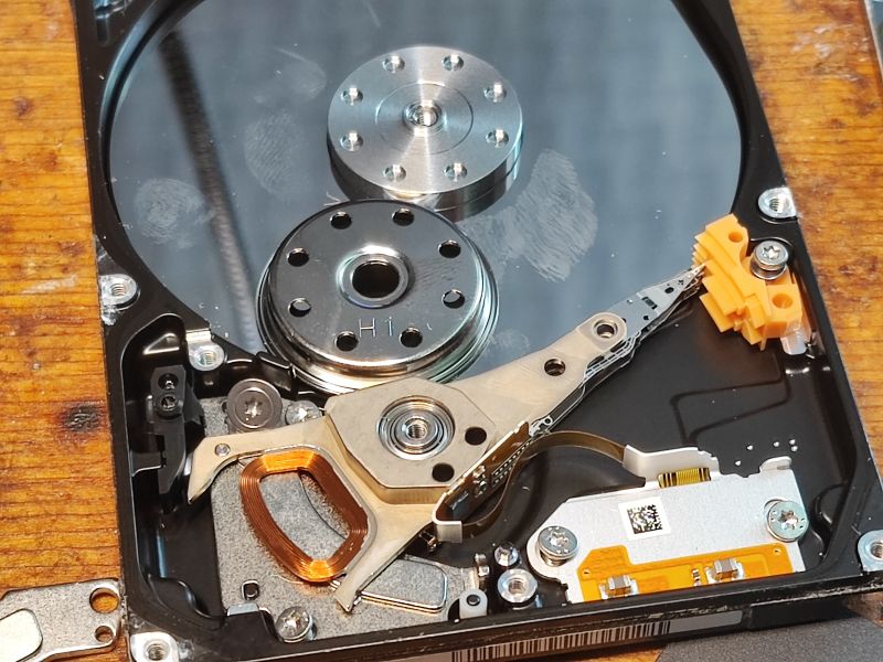 Interior of a HDD Interior of a hard disk drive with visible arm and platter.
