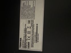 Mainboard 17MB211S for Toshiba 32L2963DG TV Mainboard 17MB211S on a table, next to a Toshiba TV with VES315UNDB-2D-N21 panel